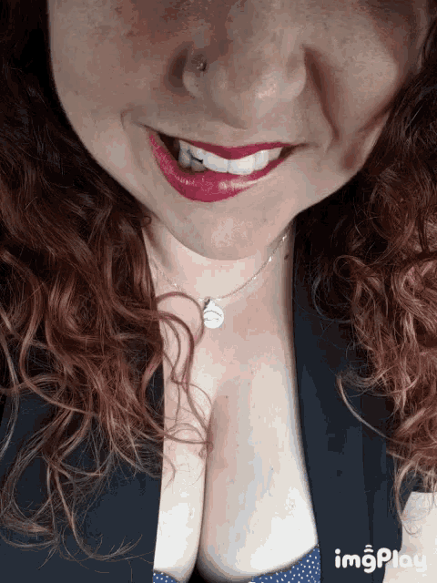 a close up of a woman 's face with red lips and a necklace that says imgplay