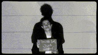 a man holds up a sign that says police 197