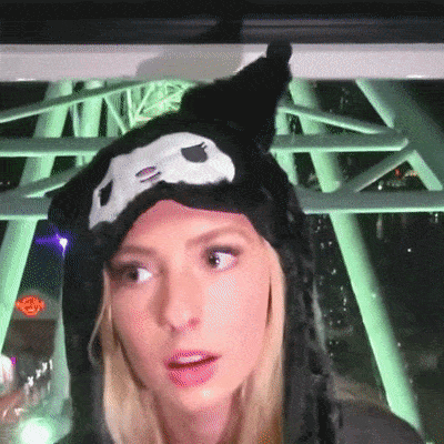 a woman wearing a black hat with a white skull on it