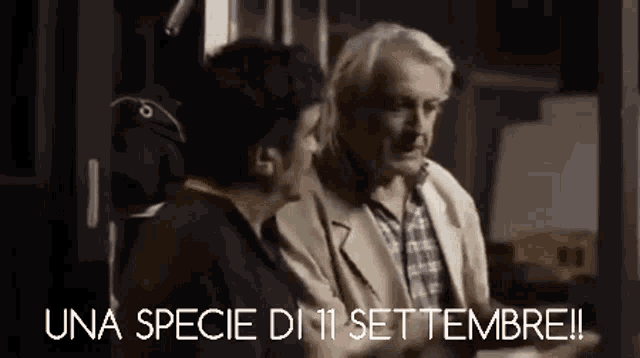 two men are talking to each other in a dark room with the words una specie di 11 settembre written on the bottom .