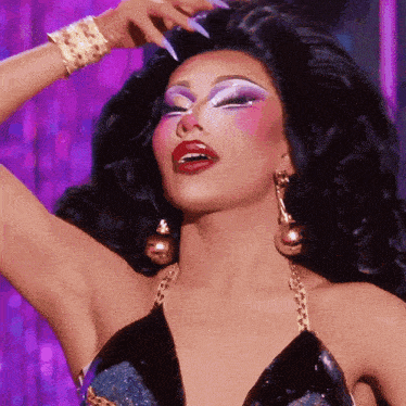 a close up of a drag queen 's face with makeup on