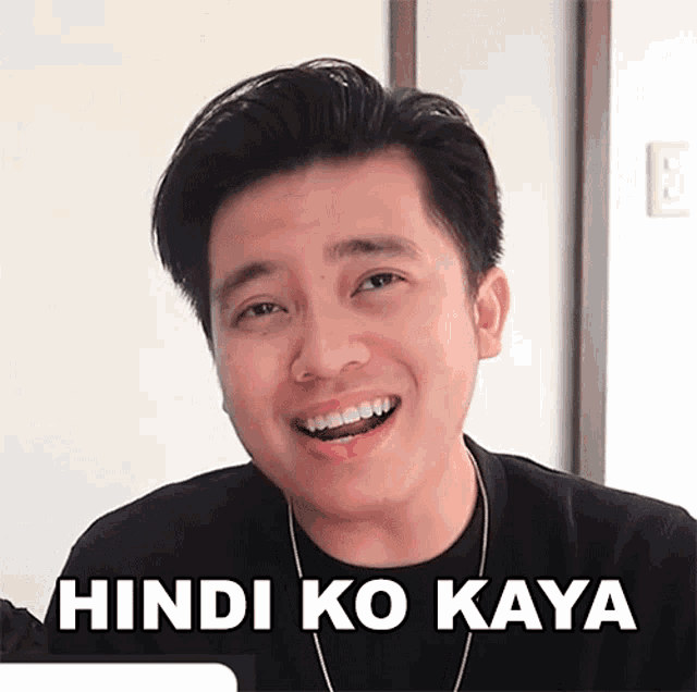 a man is smiling with the words hindi ko kaya written on his face