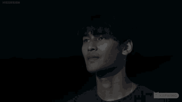 a man with his eyes closed says " why " in a dark room