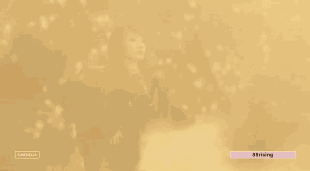 a woman in a black dress is standing in front of a glowing background with the hashtag #rising