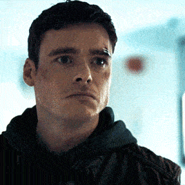 a close up of a man 's face with a black hoodie on