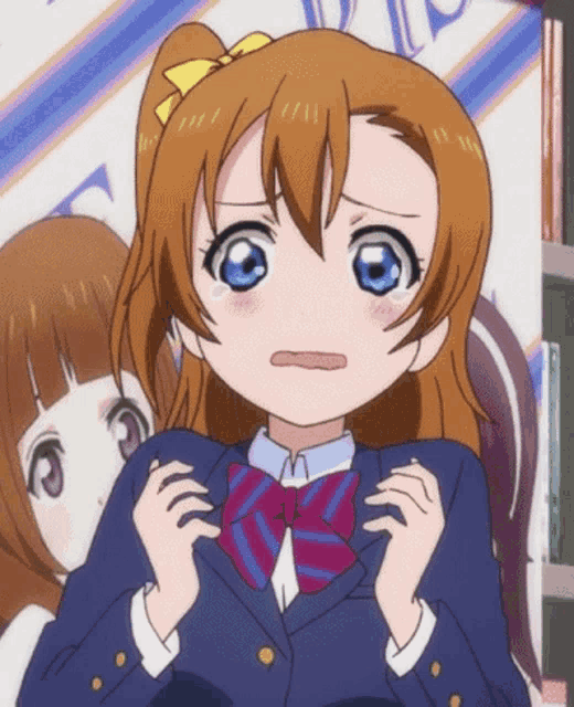 a girl with brown hair and blue eyes is wearing a purple and blue bow tie