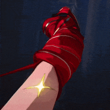 a close up of a person 's arm with a red glove on it