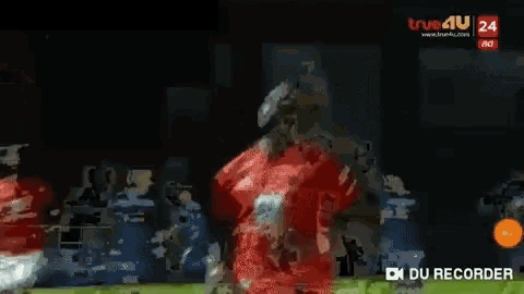 a man in a red shirt with the number 1 on it is playing soccer