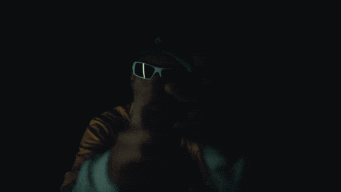 a man wearing sunglasses and a yellow shirt with bape on it