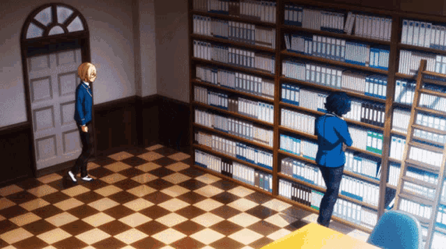 a man in a blue jacket stands in a library looking at books