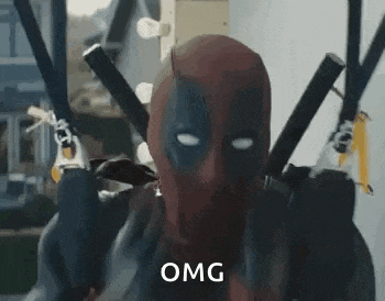 deadpool is wearing a mask and holding two swords in his hands .