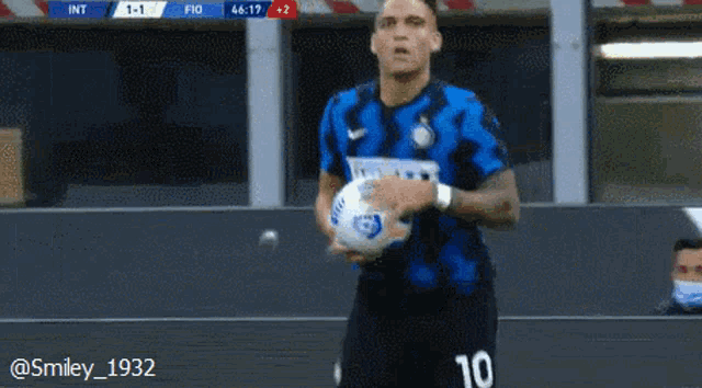a soccer player with the number 10 on his jersey holds a soccer ball