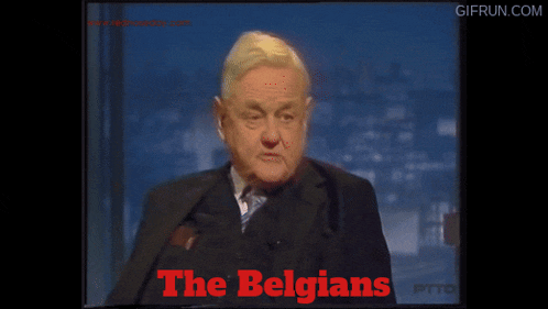 a man in a suit talks about the belgians on a television screen