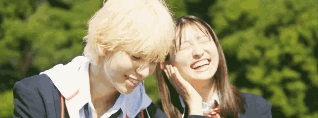 a boy and a girl are smiling and laughing together