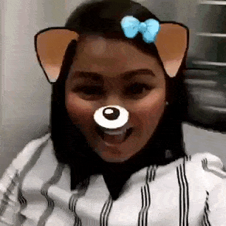 a woman wearing a dog mask with ears and a bow on her hair .