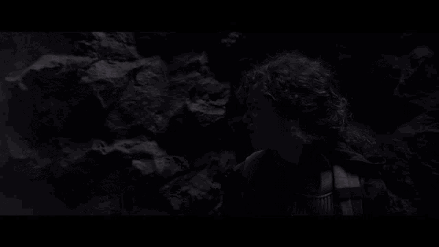 a man is laying on the ground with his mouth open in a dark room .