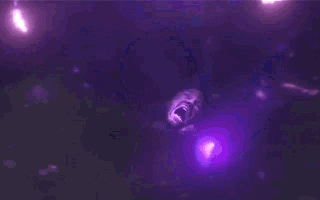 a woman is screaming in front of purple lights