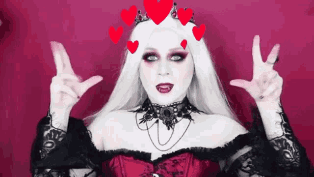 a woman with white hair and red hearts on her head