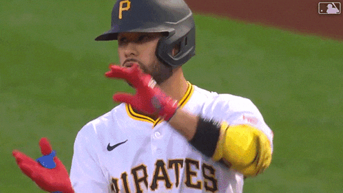 a baseball player for the pirates is wearing a helmet and gloves