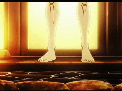 a person 's feet are standing on a stone floor