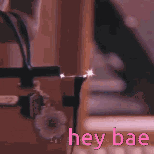 a blurred image of a person 's legs with the words hey bae written in pink