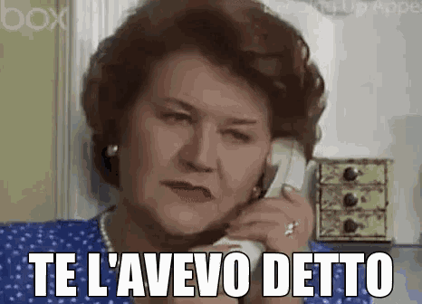 an elderly woman is talking on a phone and saying te l' avevo detto .