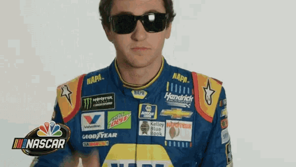 a man wearing sunglasses is wearing a napa racing uniform