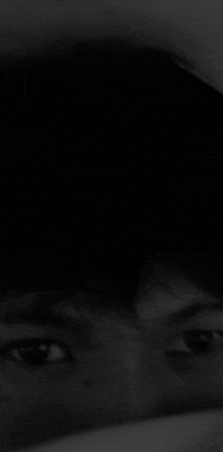 a close up of a person 's face in the dark