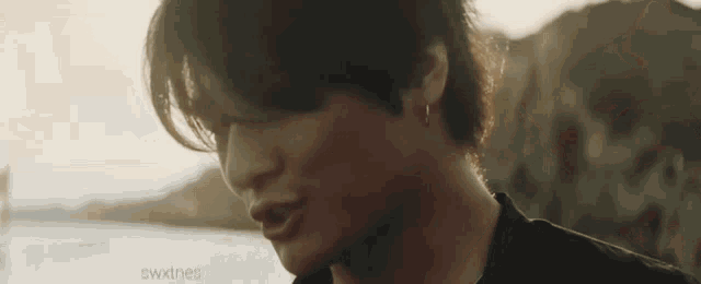 a close up of a man 's face with the sun shining on his face .