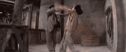 a couple of men are dancing in a room .