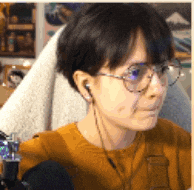 a close up of a person wearing glasses and ear buds