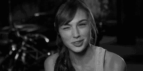 a black and white photo of a smiling woman .