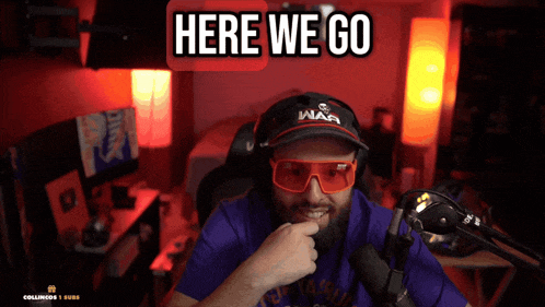 a man sitting in front of a microphone wearing a hat that says war