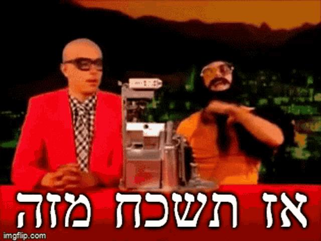 a man in a red jacket is standing next to another man in a black mask .