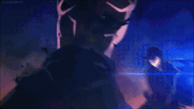 a samurai is holding a sword in a dark room