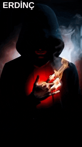 a man in a hooded jacket is holding a red heart in his hands