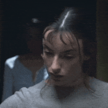 a close up of two women 's faces with one looking at the camera