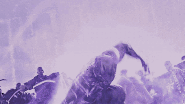 a purple background with a man kneeling down