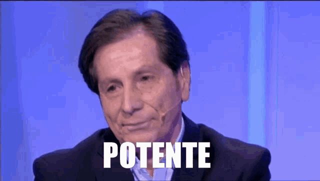 a man wearing a suit and a microphone has the word potente written on his face