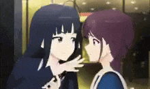 a couple of anime girls are hugging each other in a room .