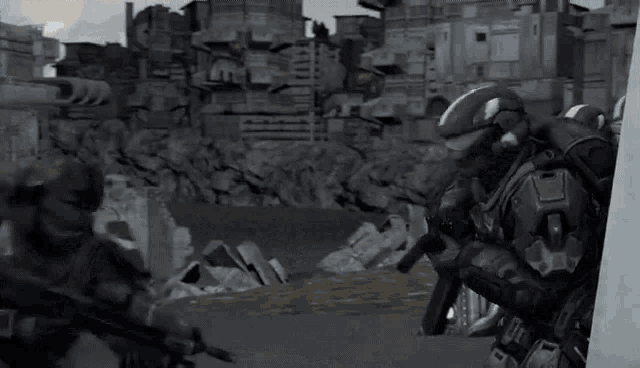 a group of soldiers are standing in front of a pile of rubble .