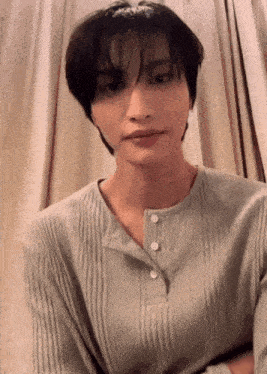 a close up of a person 's face with short hair