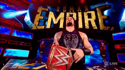 roman reigns is holding a wrestling championship belt in front of the roman empire sign