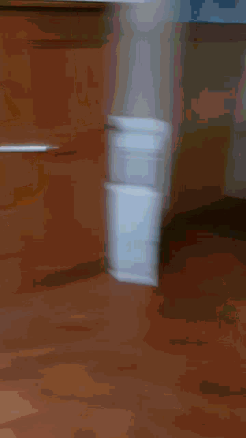 a blurry picture of a dresser with a few drawers open