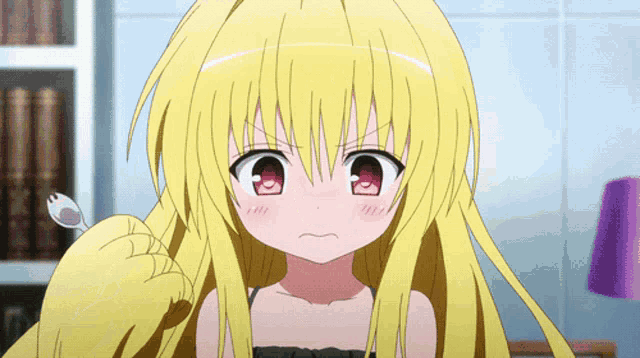 a girl with blonde hair and red eyes is looking at the camera