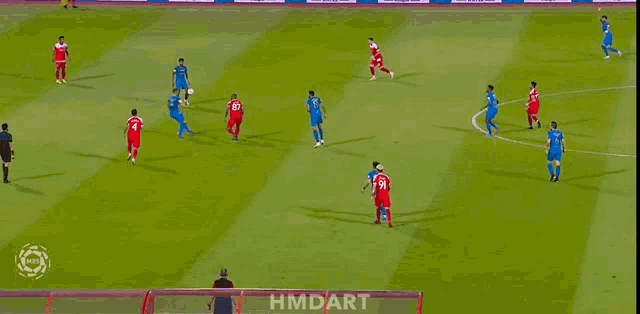 a soccer game is being played on a field with hmdart written on the fence