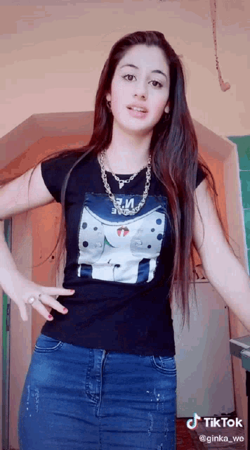 a girl wearing a black t-shirt with a picture of a person on it