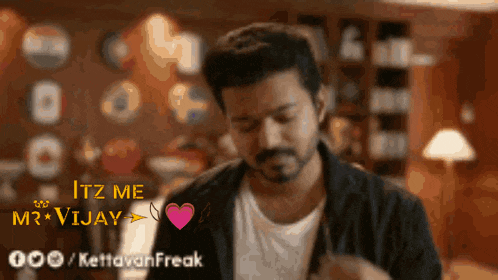 a man with a beard is standing in a room with a heart and the words itz me r vijay on the bottom