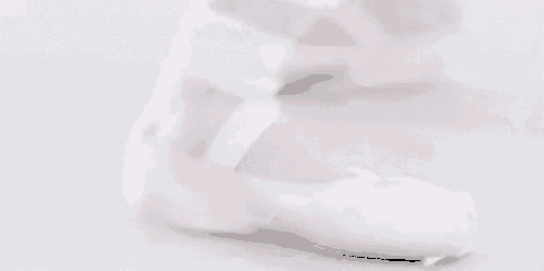 a close up of a person 's foot in white ballet shoes .