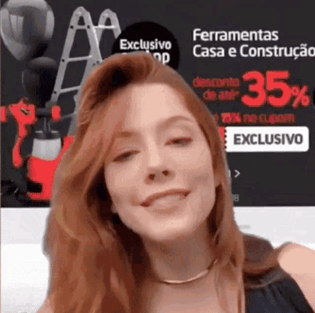 a woman is smiling in front of an advertisement for ferramentas casa e construção